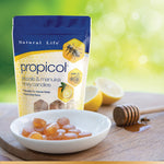 Load image into Gallery viewer, Natural Life Propicol - Propolis &amp; Manuka Honey Candies stock photo with plate of candies, lemons and stick of honey
