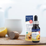 Load image into Gallery viewer, Natural Life Propolis Liquid Box and Bottle with honey, lemon and tea pot in the background
